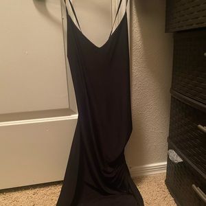 Black dress, has an opening on the leg, cross in the back